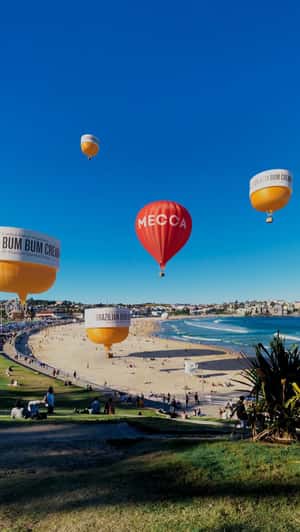 Cream Hot Air Balloons Float at Beach in a fake-out-of-home ad of Mecca