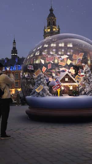 Post Stamps Floating Inside Snow Globe in a fake-out-of-home ad of La Poste