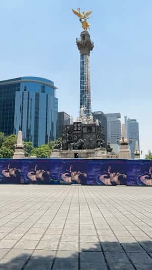 Electric Guitar Hangs on Angel Statue in a fake-out-of-home ad of Lenny Kravitz