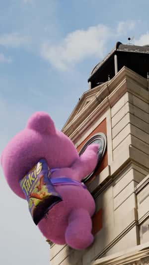 Teddy Bear Climbs at Clock  Tower in a fake-out-of-home ad of Takis