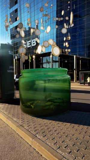 Hanging Coins Fell on Green Jar in a fake-out-of-home ad of SEB