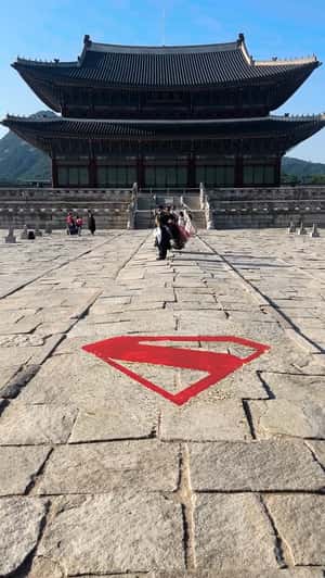 Logo Appears on Cobblestone Street in a fake-out-of-home ad of Superman
