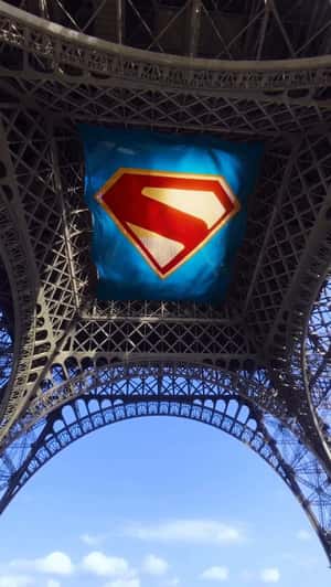 Logo on Banner Attach Under Eiffel Tower in a fake-out-of-home ad of Superman