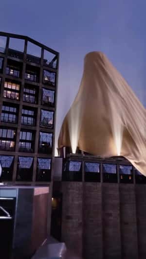 Mysterious Object Covered in Golden Cloth in a fake-out-of-home ad of D’USSÉ