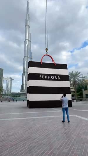 Crane Lowers Down Shopping Bag in a fake-out-of-home ad of Sephora