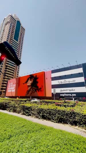 Hair Dryer Emerges Behind Billboard in a fake-out-of-home ad of Sephora