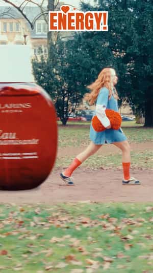 Woman Playing with Beauty Products in a fake-out-of-home ad of Clarins