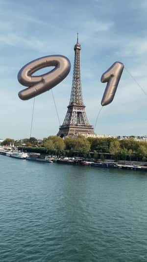 Giant Number Balloons at Eiffel Tower in fake-out-of-home ad of Porsche