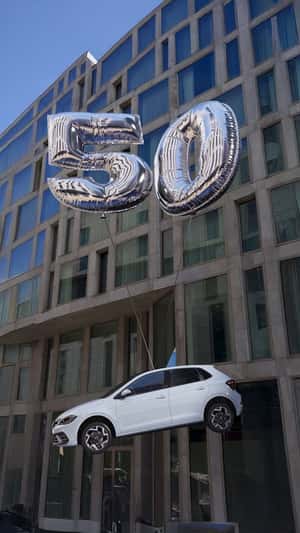 Car Floats with Number Balloon in a fake-out-of-home ad of Volkswagen
