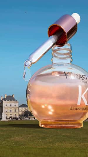 Roses Bloom with Hair Oil Drops in a fake-out-of-home ad of Kérastase