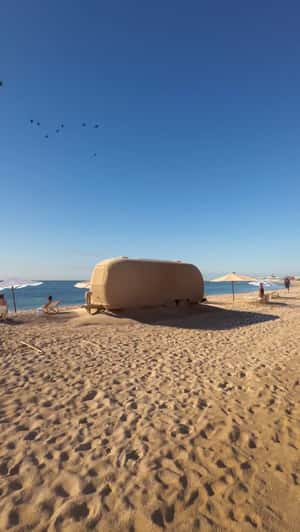 Sand-covered Trailer on Beach in a fake-out-of-home ad of Maisons du Monde
