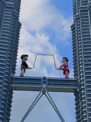 Giant Dolls Swinging Metal Rope in a fake-out-of-home-ad of Netflix