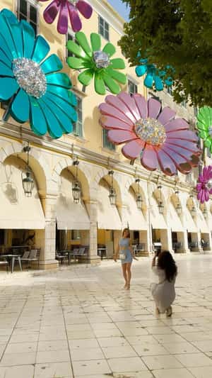 Flower Charms Shine on Façade in a fake-out-of-home ad of Anna Maria Mazaraki