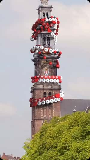 Bracelets Fell on Church Tower in a fake-out-of-home ad of Qmusic