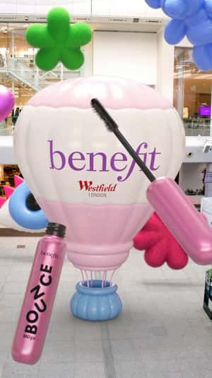 Hot Air Mascara Emerges from Hot Air Balloon in a fake-out-of-home ad of Benefit Cosmetics
