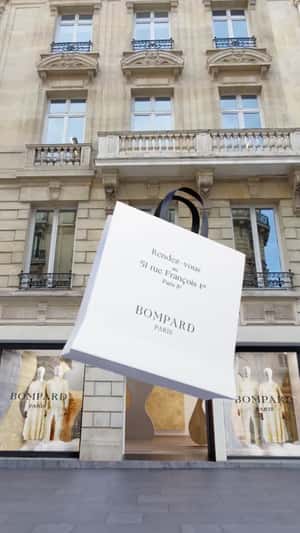 Shopping Bags Emerges from Store in a fake-out-of-home ad of Bompard