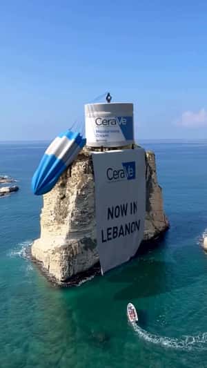 Cream on Parachute Lands on a Rock in a fake-out-of-home ad of CeraVe