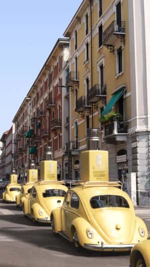 Lotion Bottles Mounted on Beetle Cars in a fake-out-of-home ad of Clinique