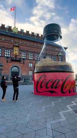 Ground Trembles as Bottle Emerges in a fake-out-of-home ad of Coca-Cola