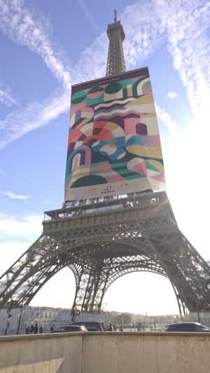 Banner Rolls Down the Eiffel Tower in a fake-out-of-home ad of Ville De Paris