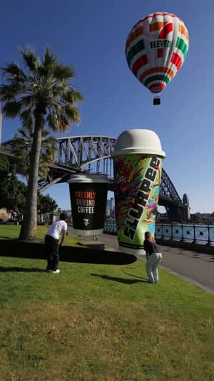 Inflated Cups Take Off Near the Bridge in a fake-out-of-home ad of 7-Eleven
