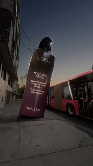 Bottle Pours Serum on Bus in a fake-out-of-home ad of L'BEL