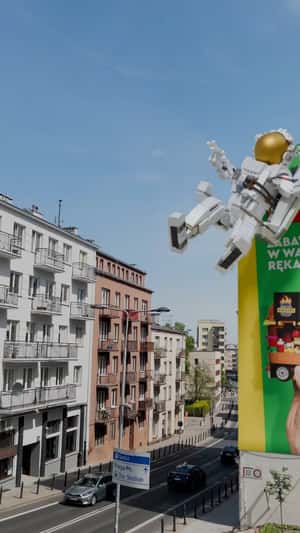 Astronaut Grabbed by Hand from Billboard in a fake-out-of-home ad of LEGO