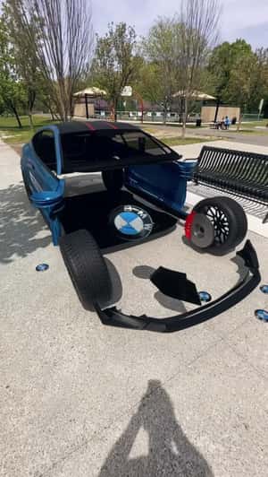 Car Assembles From BMW Button in a fake-out-of-home-ad of KIES Motorsports