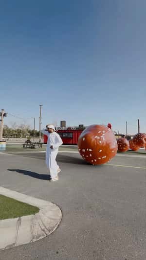 Man Chased by Rolling Delicacy in a fake-out-of-home ad of Last Exit Dubai