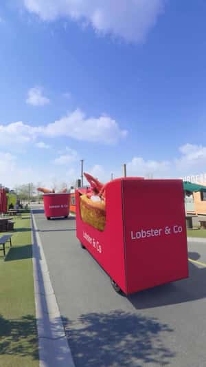 Bucket on Wheels Filled with Lobsters in a fake-out-of-home ad of Lobster & Co