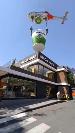 Helicopter Delivers Sunday at Rooftop in a fake-out-of-home ad on McDonald's