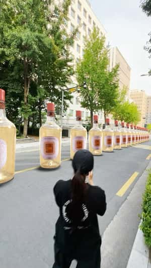 Wine Bottles in Domino Effect in a fake-out-of-home ad of Pasqua