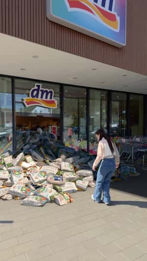 Products Piled Up at the Store Entrance in a fake-out-of-home ad of DM
