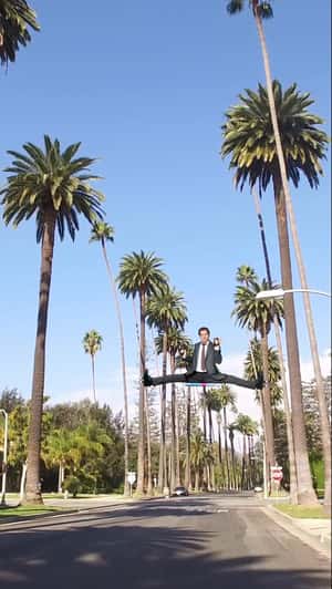 Liam Neeson Splits on Two Palm Trees in a fake-out-of-home ad of The Naked Gun