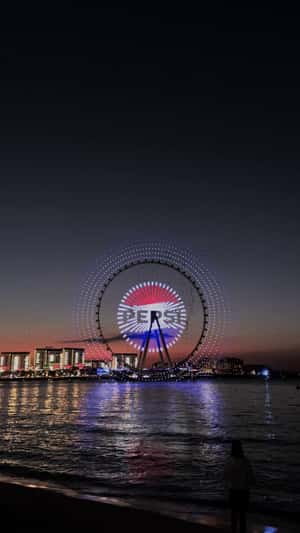 Logo Display at Ferris Wheel Light Show in a fake-out-of-home ad of Pepsi