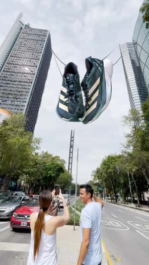 Running Shoes Hang in Between Skyscrapers in a fake-out-of-home ad of Adidas