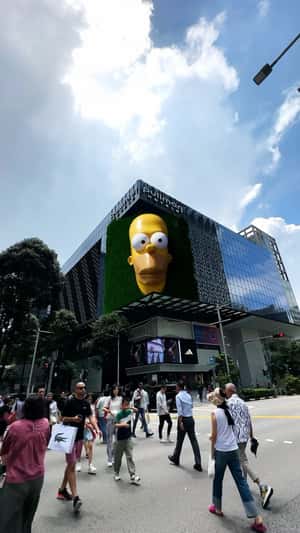 Yellow Hand Shows Sneaker at Facade in a fake-out-of-home ad of Adidas