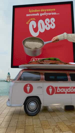 Hand Pours Pan from Ad onto Dish in a fake-out-of-home ad of Baydöner