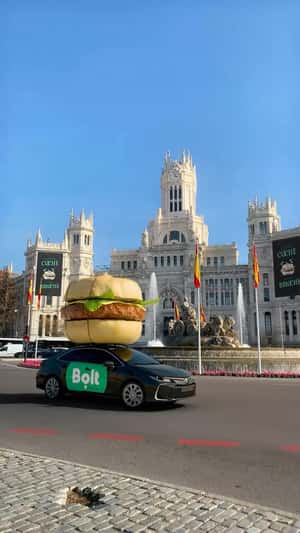 Burger Installation Above Driving Car in a fake-out-of-home ad of Bolt