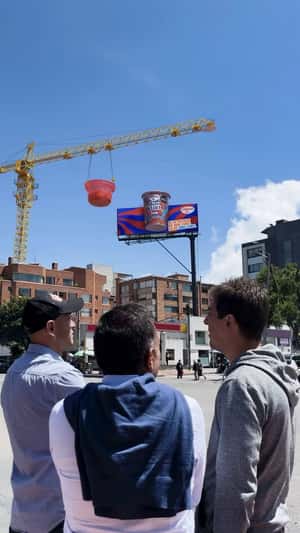 Crane Pours Cereal onto Yogurt Billboard in a fake-out-of-home ad of Bon Yurt Alpina