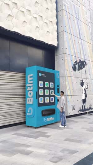 Man Gets Card from Vending Machine in a fake-out-of-home of Botim