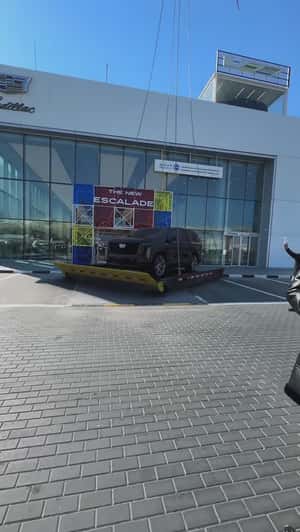 Helicopter Transports Car Outside Showroom in a fake-out-of-home ad of Cadillac