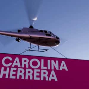 Helicopter Carrying Event Banner in a fake-out-of-home ad of Carolina Herrera