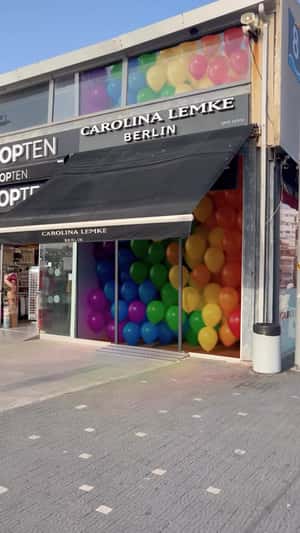 Rainbow Balloons Rising from Store in a fake-out-of-home ad of Carolina Lemke