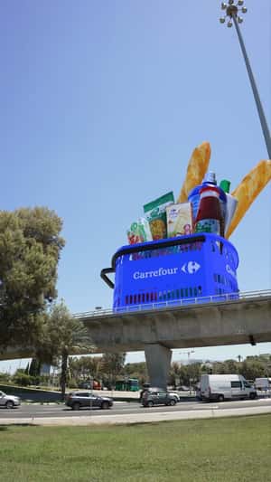 Shopping Basket Rolls on Highway in a fake-out-of home ad of Carrefour