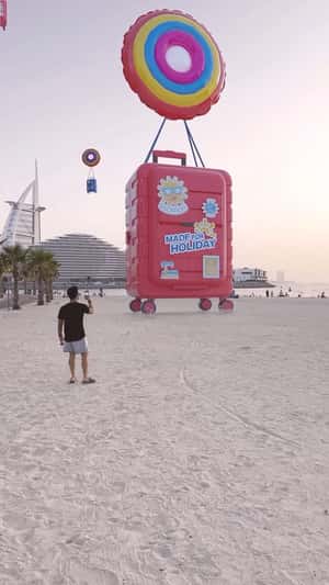 Suitcase on Inflatable Lands on Beach in a fake-out-of-home ad of Centrepoint