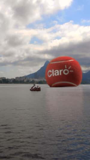 Red Tennis Ball Rolls on the Lake in a fake-out-of-home ad of Claro