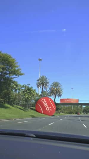 Red Tennis Ball Stuck on Footbridge in a fake-out-of-home ad of Claro