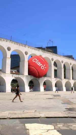 Red Tennis Ball Trapped at Arcos da Lapa in a fake-out-of-home ad of Claro