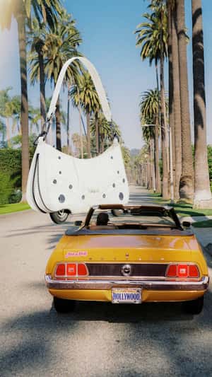 Handbag Rolls Down on Wheels in a fake-out-of-home ad of Desigual